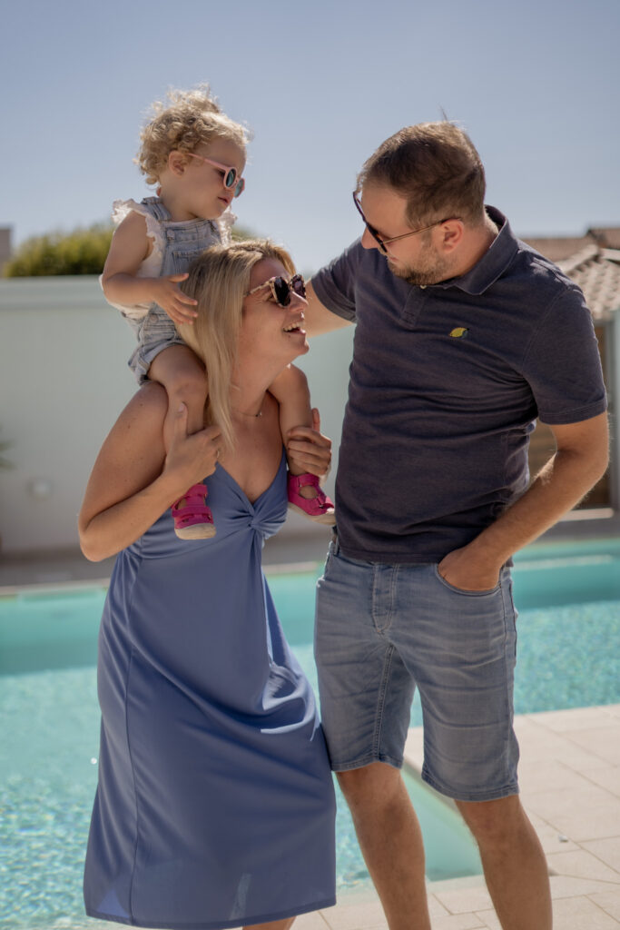 familienshooting-niederoesterreich-familie-am-pool-kind-sitzt-auf-mutters-schultern